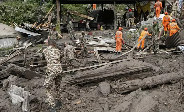 India's National Disaster Response Force (NDRF) and other security personnel carry out a rescue operation after Thursday's flash floods in Chositi village, Kishtwar district, Indian-controlled Kashmir, Friday, Aug. 15, 2025. (AP Photo/Channi Anand)