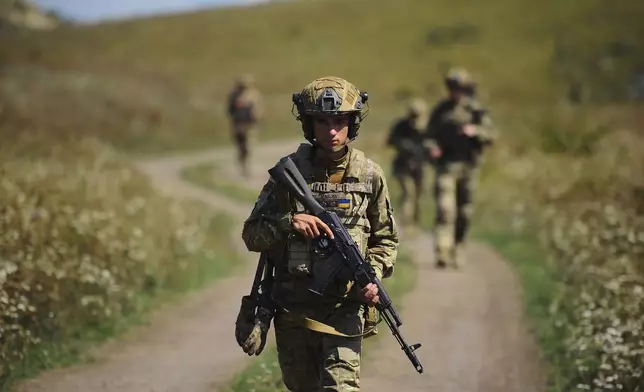 In this photo, taken on Tuesday, Aug. 19, 2025 and provided by Ukraine's 127th Separate Brigade of the Territorial Defence press service, soldiers aged 18 to 24 practice military skills on a training ground near Kharkiv, Ukraine. (Anatolii Lysianskyi/Ukraine's 127th Separate Brigade via AP)