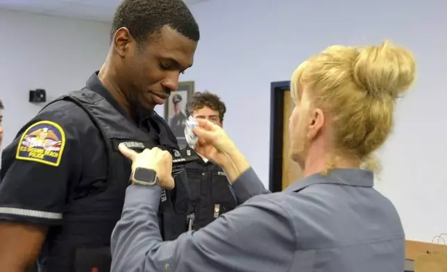 FILE - In this undated photo provided by Old Orchard Beach Police Department, Officer Jon Luke Evans receives his police badge. (Old Orchard Beach Police Department via AP, File)