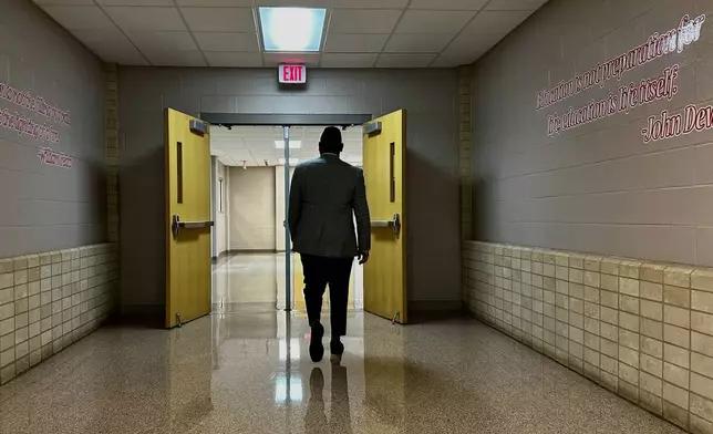 Chief of Talent at New Schools for New Orleans, Jahquille Ross, walks down a hallway at Alice Hart Charter School in New Orleans, on July 30, 2025. (AP Photo/Stephen Smith)