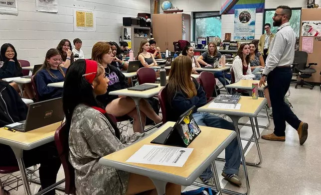 Benjamin Franklin High School teacher Chris Dier introduces the syllabus to students on the second day of classes, on Aug. 12, 2025, in New Orleans. (AP Photo/Stephen Smith)