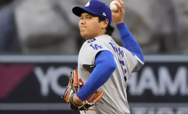 Los Angeles Dodgers starting pitcher Shohei Ohtani throws to the plate during the third inning of a baseball game against the Los Angeles Angels, Wednesday, Aug. 13, 2025, in Anaheim, Calif. (AP Photo/Mark J. Terrill)