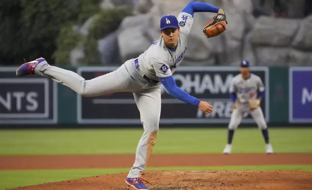 Los Angeles Dodgers starting pitcher Shohei Ohtani throws to the plate during the third inning of a baseball game against the Los Angeles Angels, Wednesday, Aug. 13, 2025, in Anaheim, Calif. (AP Photo/Mark J. Terrill)
