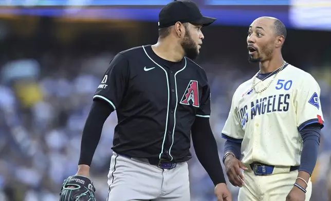 Arizona Diamondbacks pitcher Eduardo Rodriguez has a word with Los Angeles Dodgers baserunner Mookie Betts in the third inning of a baseball game Saturday, Aug. 30, 2025, in Los Angeles. (AP Photo/Wally Skalij)