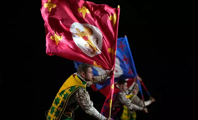 Italian Historic Flag-Weavers of the Contrade of Cori perform during a dress rehearsal of the Spasskaya Tower International Military Music Festival on the Red square in Moscow, Russia, Thursday, Aug. 21, 2025. (AP Photo/Pavel Bednyakov)