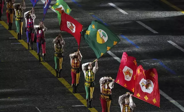 Members of an Italian group Historicl Flag Wavers of the Contrade of Cori perform during a dress rehearsal of the Spasskaya Tower International Military Music Festival on the Red square in Moscow, Thursday, Aug. 21, 2025. (AP Photo/Alexander Zemlianichenko)