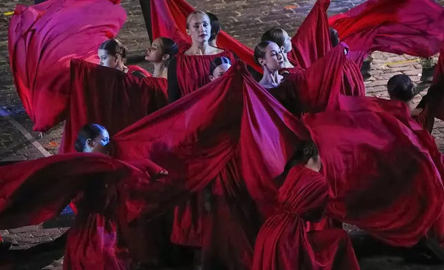 Actors perform during a dress rehearsal of the Spasskaya Tower International Military Music Festival in Red Square in front of the St. Basil Cathedral and the Spasskaya Tower in Moscow, Russia, Thursday, Aug. 21, 2025. (AP Photo/Alexander Zemlianichenko)