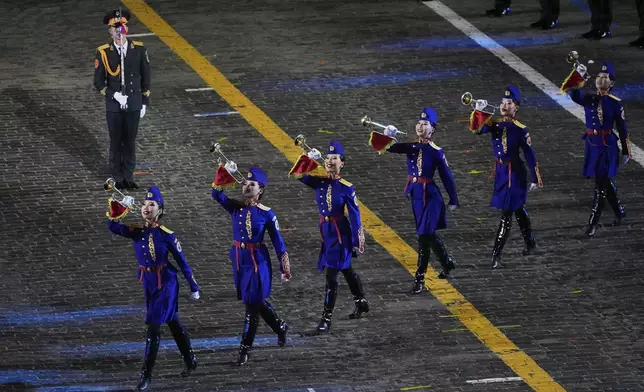 Members of the Mongolian Military Song and Dance Academic Ensemble perform during a dress rehearsal of the Spasskaya Tower International Military Music Festival in Red Square in front of the St. Basil Cathedral and the Spasskaya Tower in Moscow, Russia, Thursday, Aug. 21, 2025. (AP Photo/Alexander Zemlianichenko)