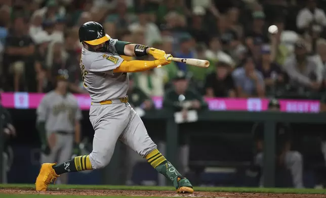 Athletics' Shea Langeliers hits an RBI double against the Seattle Mariners during the 10th inning of a baseball game Saturday, Aug. 23, 2025, in Seattle. (AP Photo/Lindsey Wasson)