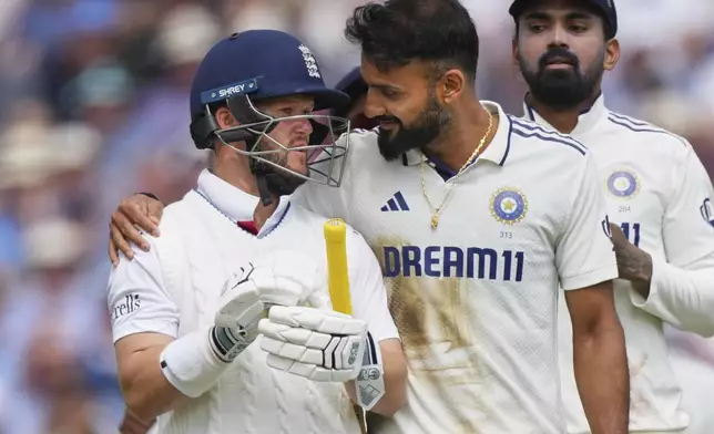 India's Akash Deep puts his arm around England's Ben Duckett after taking his wicket during the second day of the fifth cricket test match between England and India at The Kia Oval in London, Friday, Aug. 1, 2025. (AP Photo/Kirsty Wigglesworth)