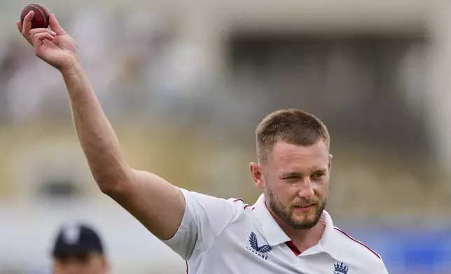 England's Gus Atkinson celebrates with the ball after gets five wickets during the second day of the fifth cricket test match between England and India at The Kia Oval in London, Friday, Aug. 1, 2025. (AP Photo/Kirsty Wigglesworth)