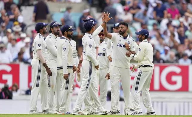 India's Mohammed Siraj, second right, celebrates with teammates after the dismissal of England's Joe Root during the second day of the fifth cricket test match between England and India at The Kia Oval in London, Friday, Aug. 1, 2025. (AP Photo/Kirsty Wigglesworth)