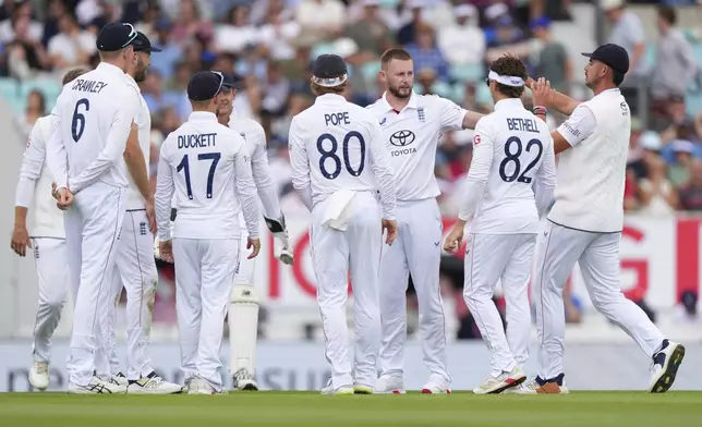 England's Gus Atkinson, third from right, celebrates with teammates after the dismissal of India's Mohammed Siraj during the second day of the fifth cricket test match between England and India at The Kia Oval in London, Friday, Aug. 1, 2025. (AP Photo/Kirsty Wigglesworth)
