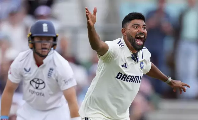 India's Mohammed Siraj appeals successfully for the wicket of England's Ollie Pope, left, during the second day of the fifth cricket test match between England and India at The Kia Oval in London, Friday, Aug. 1, 2025. (AP Photo/Kirsty Wigglesworth)