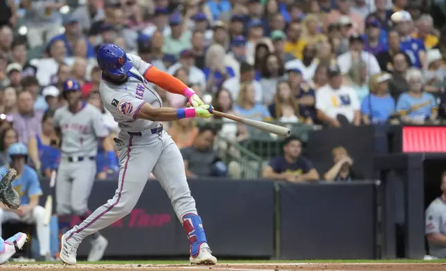 New York Mets' Starling Marte hits a solo home run during the second inning of a baseball game against the Milwaukee Brewers, Friday, Aug. 8, 2025, in Milwaukee. (AP Photo/Aaron Gash)