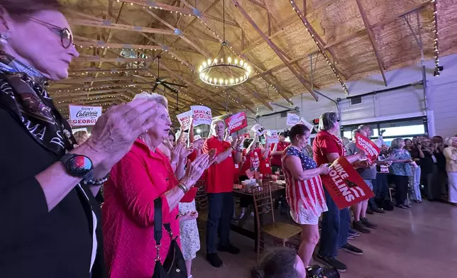 Supporters applaud at a U.S. Senate campaign event for Republican U.S. Rep. Mike Collins in Jackson, Ga. (AP Photo/Jeff Amy)