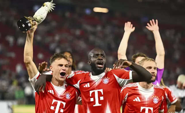 Bayern's, from left, Joshua Kimmich, Dayot Upamecano and Konrad Laimer celebrate after winning the German Supercup final soccer match between VfB Stuttgart and Bayern Munich in Stuttgart, Germany, Saturday, Aug. 16, 2025. (Tom Weller/dpa via AP)