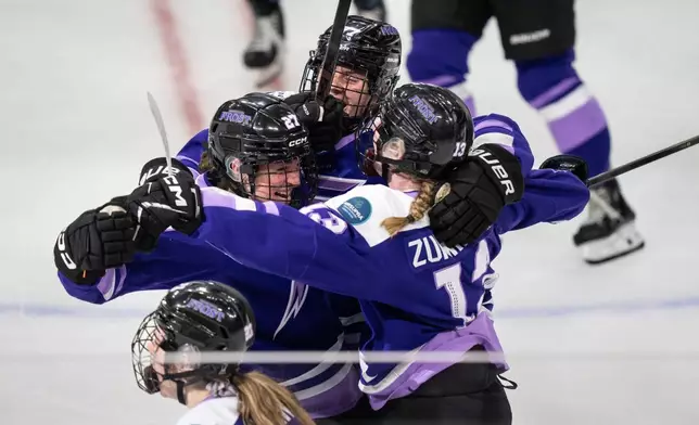 FILE - Minnesota Frost forward Taylor Heise (27), left, is surrounded by teammates, Minnesota Frost forward Britta Curl (77) and Minnesota Frost forward Grace Zumwinkle (13) after she scored the winning goal in overtime of the PWHL Walter Cup in St. Paul, Minn., Wednesday, May 14, 2025. (Renée Jones Schneider/Star Tribune via AP)