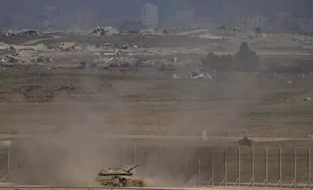 An Israeli tank moves along the Israeli-Gaza border as seen from southern Israel, Thursday, Aug. 28, 2025. (AP Photo/Maya Levin)