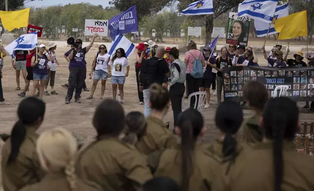 Relatives and supporters of hostages held by Hamas in the Gaza Strip take part in a protest calling for their release as they stand at the site where revelers were killed on Oct. 7, 2023, at the Nova music festival, near the Kibbutz Reim, southern Israel, Thursday, Aug. 28, 2025. (AP Photo/Maya Levin)