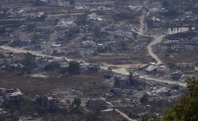 U.N. vehicles drive through destruction near the Lebanese-Israeli border in the village of Kfra Kila, southern Lebanon, Wednesday, Aug. 20, 2025. (AP Photo/Hussein Malla)