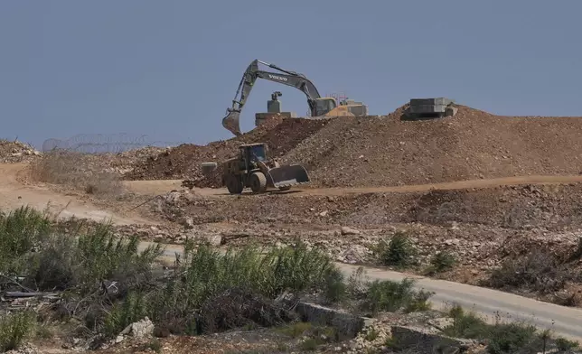 Israeli bulldozers work at one of five new positions the Israeli army established inside Lebanese territory along a road between Houla and Kfar Kila, border villages destroyed by Israeli airstrikes and a ground offensive, in south Lebanon, Wednesday, Aug. 20, 2025. (AP Photo/Hussein Malla)