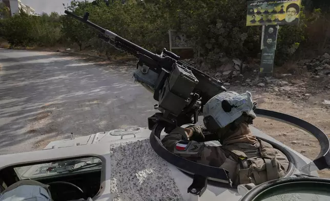 A French U.N. peacekeeper rides on an armored vehicle during a patrol along the Lebanese-Israeli border in the village of Kfra Kila, southern Lebanon, Wednesday, Aug. 20, 2025. (AP Photo/Hussein Malla)