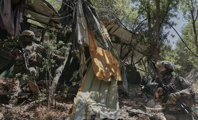 A French U.N. peacekeeper examines a destroyed position Hezbollah in the Saluki Valley, southern Lebanon, Wednesday, Aug. 20, 2025. (AP Photo/Hussein Malla)
