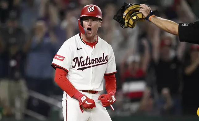 Washington Nationals' Robert Hassell III celebrates after he scored the game winning run on a walk-off single by CJ Abrams during the ninth inning of a baseball game against the Athletics, Wednesday, Aug. 6, 2025, in Washington. (AP Photo/Nick Wass)