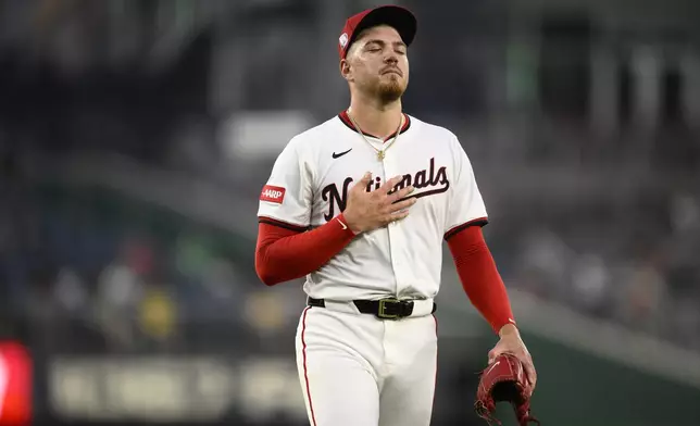 Washington Nationals starting pitcher Cade Cavalli walks back to the dugout after he was pulled during the fifth inning of a baseball game against the Athletics, Wednesday, Aug. 6, 2025, in Washington. (AP Photo/Nick Wass)