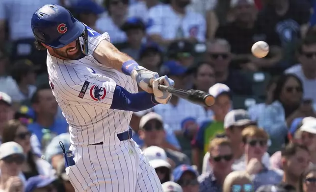 Chicago Cubs' Dansby Swanson hits a one-run single during the sixth inning of a baseball game against the Baltimore Orioles in Chicago, Sunday, Aug. 3, 2025. (AP Photo/Nam Y. Huh)
