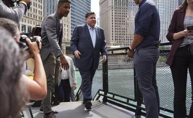 Illinois Governor JB Pritzker arrives for a news conference in a Chicago water taxi Monday, Aug. 25, 2025, in Chicago. (AP Photo/Nam Y. Huh)