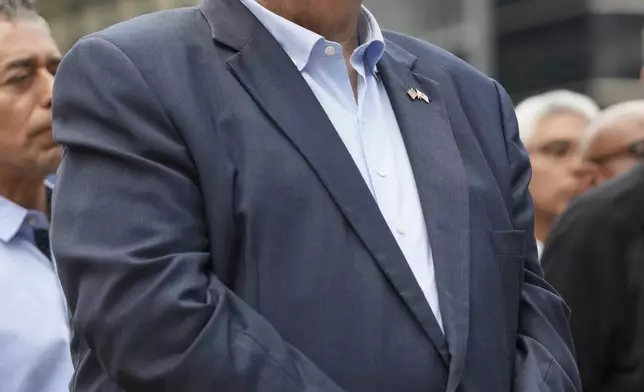 Illinois Governor JB Pritzker listens to Chicago Mayor Brandon Johnson's speech during a news conference at River Point Park, Monday, Aug.. 25, 2025, in Chicago. (AP Photo/Nam Y. Huh)