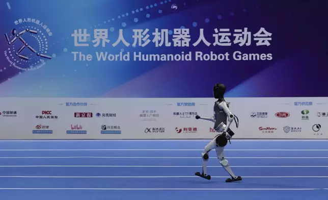 A robot competes in a race during the World Humanoid Robot Games in Beijing, China, Friday, Aug. 15, 2025. (AP Photo/Mahesh Kumar A.)