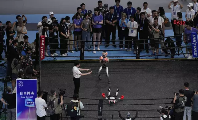 Robots participate in the Free Combat event at the World Humanoid Robot Games held in Beijing, China, Friday, Aug. 15, 2025. (AP Photo/Mahesh Kumar A.)