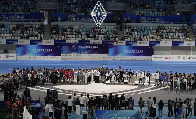 Winners from different games pose for celebratory photographs during the closing ceremony of the World Humanoid Robot Games held in Beijing, China, Sunday, Aug. 17, 2025. (AP Photo/Mahesh Kumar A.)