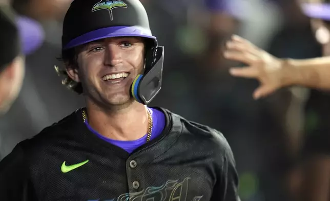 Tampa Bay Rays' Carson Williams celebrates in the dugout after his two-run home run off St. Louis Cardinals pitcher Ryan Fernandez during the seventh inning of a baseball game Friday, Aug. 22, 2025, in Tampa, Fla. (AP Photo/Chris O'Meara)