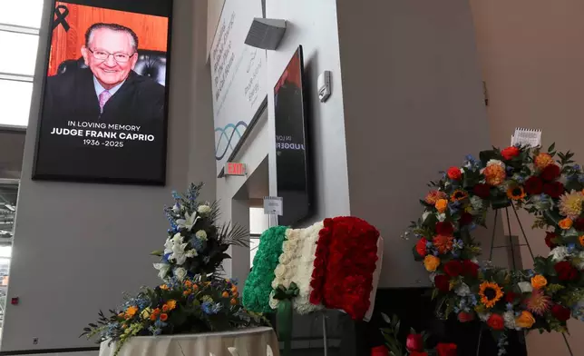 Flowers are displayed at the visiting hours for former Judge Frank Caprio at the Rhode Island Convention Center in Providence, R.I. on Thursday, Aug. 28, 2025. (AP Photo/Leah Willingham)