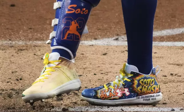 New York Mets' Juan Soto grooms the batter's box wearing custom shoes for Players' Weekend during the first inning of the Little League Classic baseball game against the Seattle Mariners at Bowman Field in Williamsport, Pa., Sunday, Aug. 17, 2025. (AP Photo/Gene J. Puskar)
