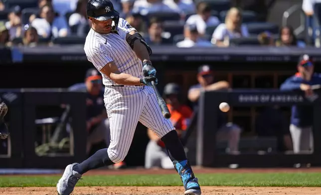 New York Yankees' Giancarlo Stanton hits a RBI single during the fifth inning of a baseball game against the Houston Astros, Saturday, Aug. 9, 2025, in New York. (AP Photo/Yuki Iwamura)