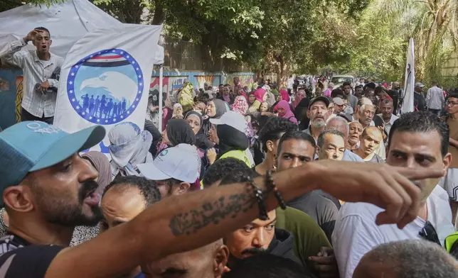 Voters line up at a polling station during the first day of the Senate election, in Cairo, Egypt, Monday, Aug. 4, 2025. (AP Photo/Amr Nabil)