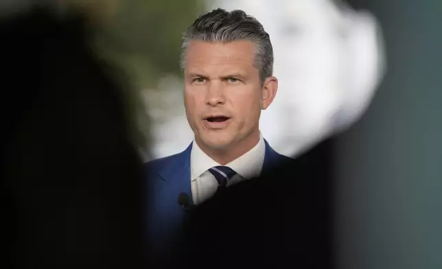 Defense Secretary Pete Hegseth speaks during a television interview outside the White House Thursday, Aug. 7, 2025, in Washington. (AP Photo/Mark Schiefelbein)