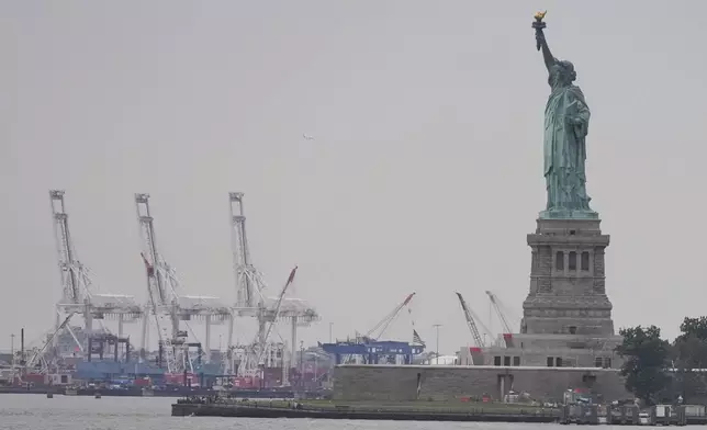 The Statue of Liberty is seen near Port Liberty Terminals, Wednesday, Aug. 6, 2025, in New York. (AP Photo/Frank Franklin II)