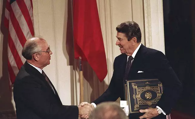 FILE - In this Dec. 8, 1987, file photo, U.S. President Ronald Reagan, right, shakes hands with Soviet leader Mikhail Gorbachev after the two leaders signed the Intermediate Range Nuclear Forces Treaty to eliminate intermediate-range missiles during a ceremony in the White House East Room in Washington. (AP Photo/Bob Daugherty, File)