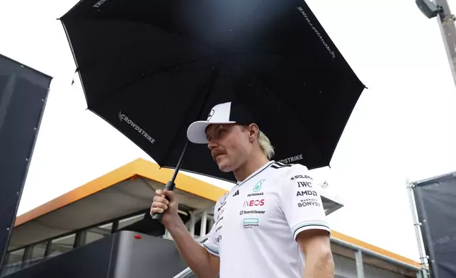 Reserve Mercedes driver Valtteri Bottas of Finland arrives in the paddock ahead of the Formula One Grand Prix at the Spa-Francorchamps racetrack in Spa, Belgium, Thursday, July 24, 2025. (AP Photo/Geert Vanden Wijngaert)