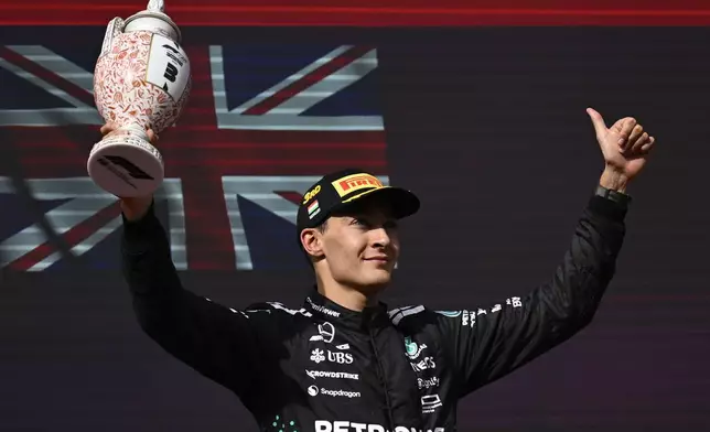 Mercedes driver George Russell of Britain celebrates his third place after the Hungarian Formula One Grand Prix race at the Hungaroring racetrack in Mogyorod, Hungary, Sunday, Aug. 3, 2025. (AP Photo/Denes Erdos)