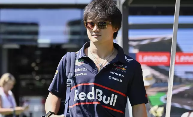 Red Bull driver Yuki Tsunoda of Japan walks through the paddock at the Hungaroring racetrack in Mogyorod, Hungary, Friday, Aug. 1, 2025, ahead of the Hungarian Formula One Grand Prix. (AP Photo/Denes Erdos)