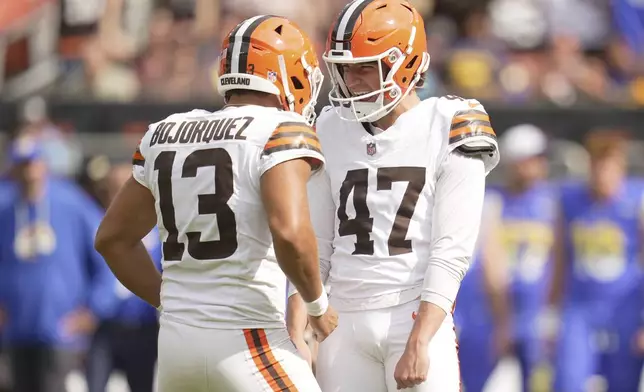 Cleveland Browns place kicker Andre Szmyt (47) celebrates with place holder Corey Bojorquez (13) after making the game-winning field goal in an NFL preseason football game against the Los Angeles Rams, Saturday, Aug. 23, 2025, in Cleveland. (AP Photo/Sue Ogrocki)
