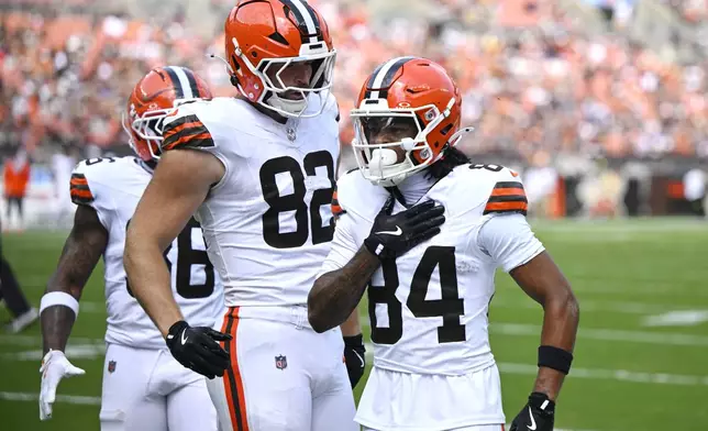 Cleveland Browns wide receiver Gage Larvadain (84) celebrates with tight end Brenden Bates (82) after scoring a touchdown against the Los Angeles Rams in the first half of an NFL preseason football game Saturday, Aug. 23, 2025, in Cleveland. (AP Photo/David Richard)