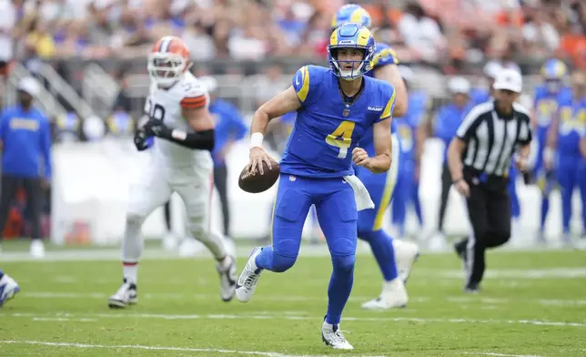 Los Angeles Rams quarterback Dresser Winn (4) rolls out during the first half of an NFL preseason football game against the Cleveland Browns, Saturday, Aug. 23, 2025, in Cleveland. (AP Photo/Sue Ogrocki)